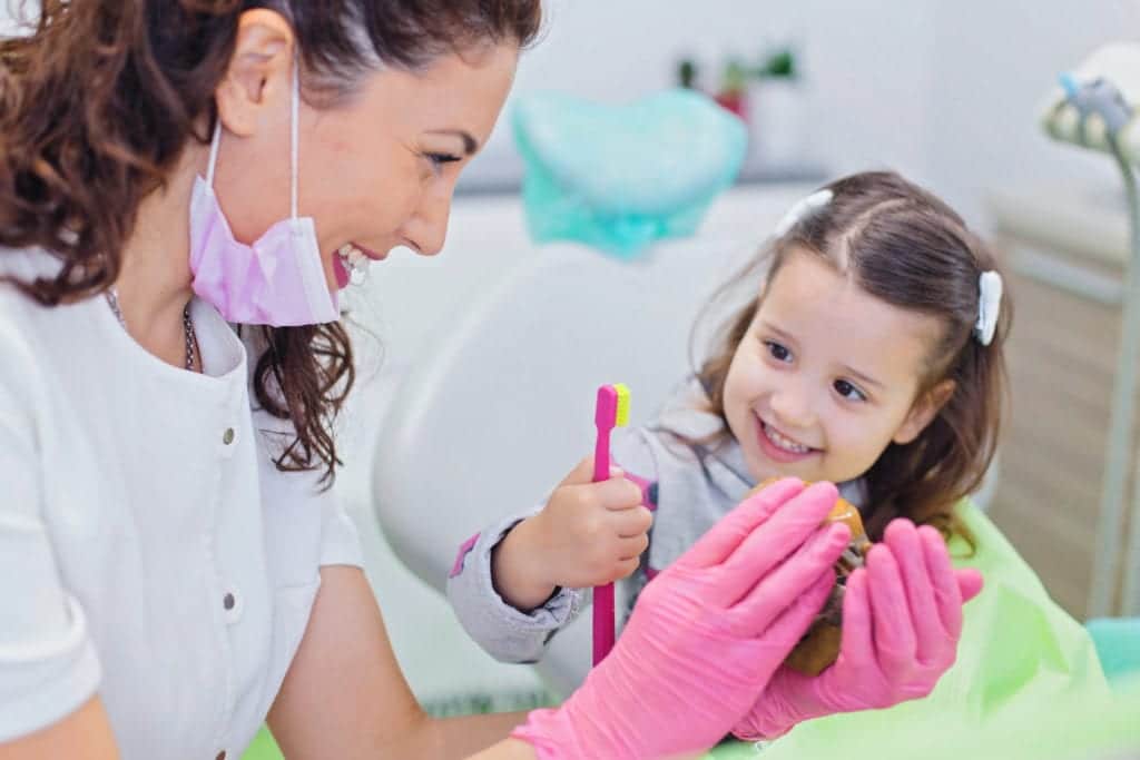 Happy children with doctor in toronto clinic